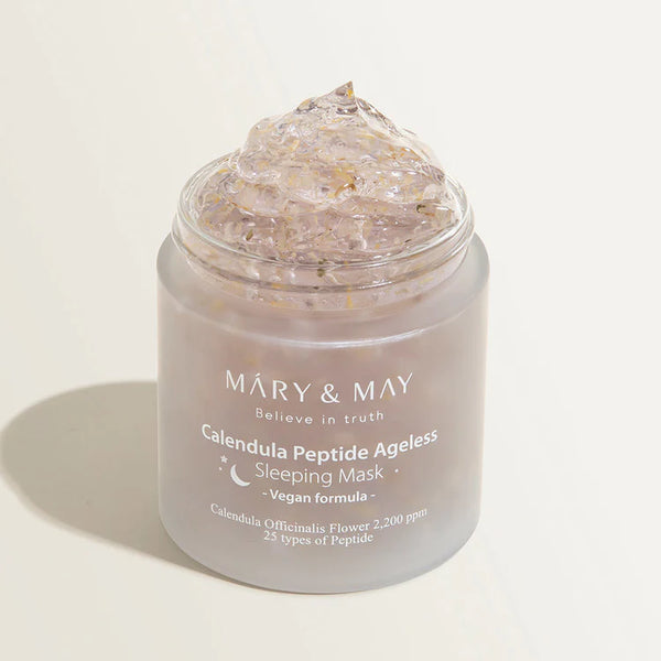 Open jar of MARY & MAY Calendula Peptide Ageless Sleeping Mask with a detailed view of its gel-like texture with visible petal inclusions.
