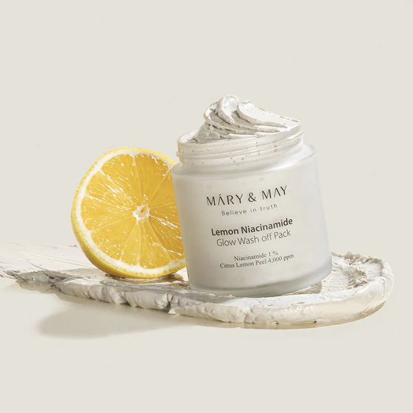 MARY & MAY Lemon Niacinamide Glow Wash Off Pack with a fresh lemon slice, highlighting the product's brightening ingredients.
