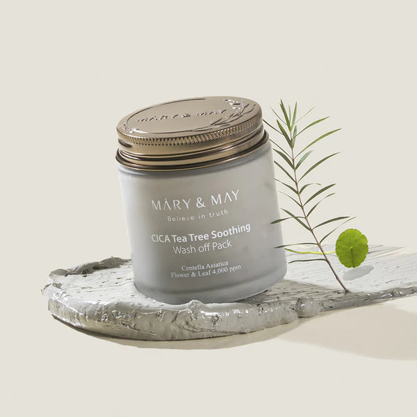 Side view of MARY & MAY CICA Tea Tree Soothing Wash Off Pack with a plant sprig, emphasizing the natural ingredients and soothing properties.