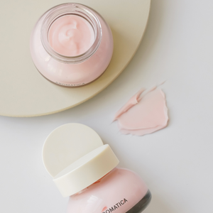 Open jar and creamy texture of Aromatica's Rose face cream.