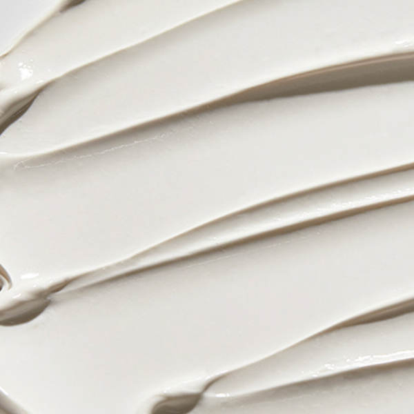 Creamy white texture of anua 70% heartleaf mud cream mask.