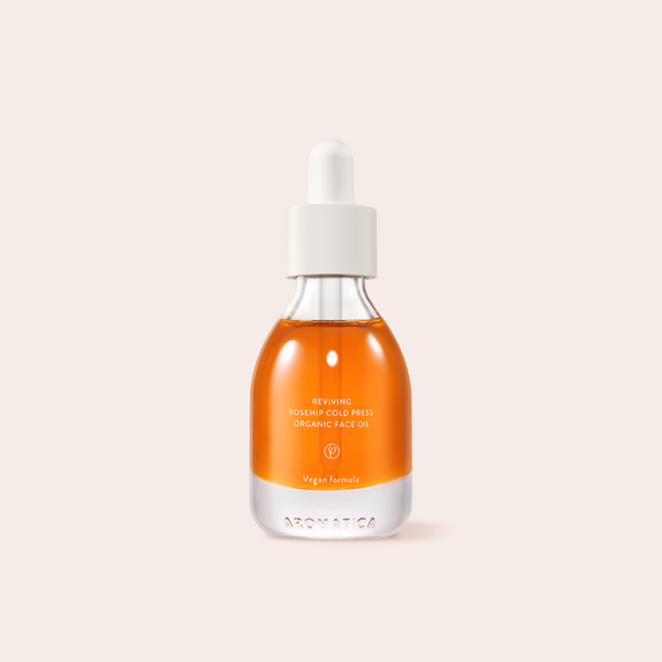 Bright orange Aromatica Reviving Rosehip Cold Press Organic Face Oil in glass bottle packaging