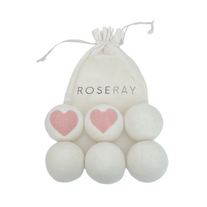 Six Roseray Wool Dryer Balls, two white with baby pink hearts and four white ones. Roseray reusable cotton bag also shown.