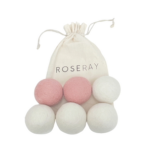 Six Roseray wool dryer balls. Two baby pink ones and 4 white dryer balls. Roseray reusable cotton bag also shown.