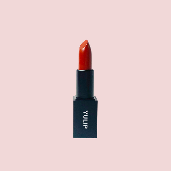 Yulip lipstick in Gochujang, a deep chili red in black packaging