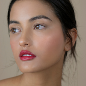 Model wearing Yulip bright deep pink natural lipstick